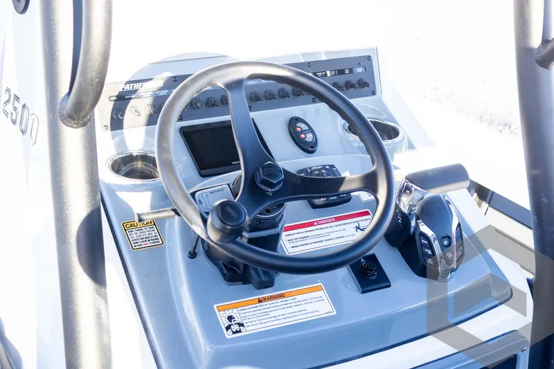Slide: The Image of 2025 Pathfinder 2500 Hybrid boat console with steering wheel and controls. - 43