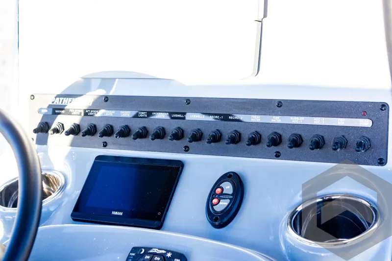 Slide: The Image of Control panel of 2025 Pathfinder 2500 Hybrid boat with switches and display. - 46