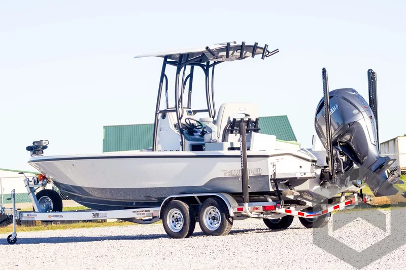 Slide: The Image of 2025 Pathfinder 2500 Hybrid boat on trailer with outboard motor, parked on gravel. - 5