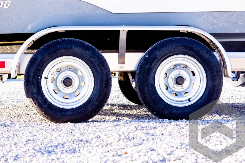 Slide: The Image of Pathfinder 2500 Hybrid 2025 trailer wheels on gravel surface. - 9