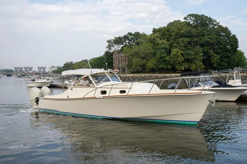 Slide: The Image of 2021 Brooklin Boat Yard 32 Express cruising on a calm river near a marina. - 0