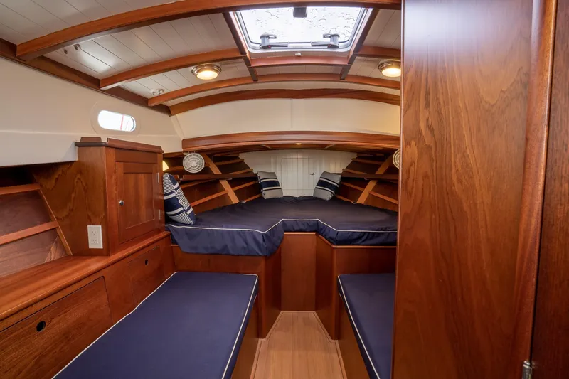 Slide: The Image of Luxurious 2021 Brooklin Boat Yard 32 Express cabin with elegant wood finish and cozy seating. - 11