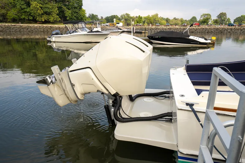 Slide: The Image of Brooklin Boat Yard 32 Express 2021 with outboard motor in a calm marina setting. - 20