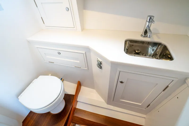 Slide: The Image of Compact bathroom in 2021 Brooklin Boat Yard 32 Express, featuring toilet and sink. - 21