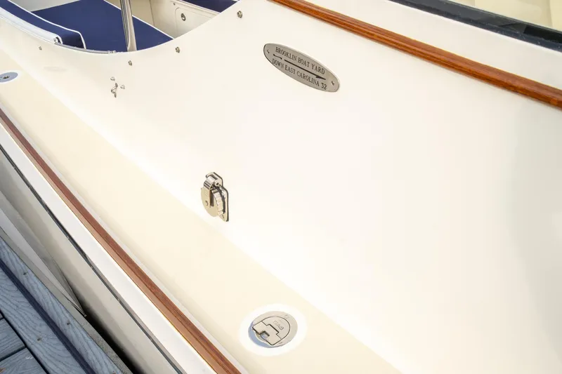 Slide: The Image of 2021 Brooklin Boat Yard 32 Express, sleek design with wood trim and metal fixtures. - 23
