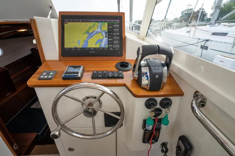 Slide: The Image of Helm of 2021 Brooklin Boat Yard 32 Express with navigation display and controls. - 30