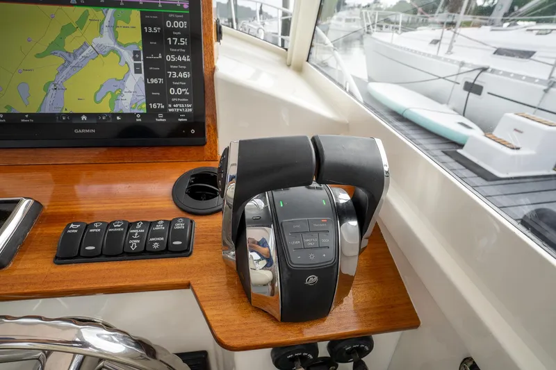Slide: The Image of Control panel of 2021 Brooklin Boat Yard 32 Express with navigation display and throttle controls. - 31