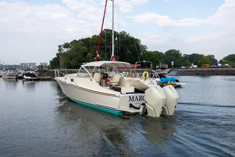 Slide: The Image of 2021 Brooklin Boat Yard 32 Express cruising in a marina with scenic background. - 4
