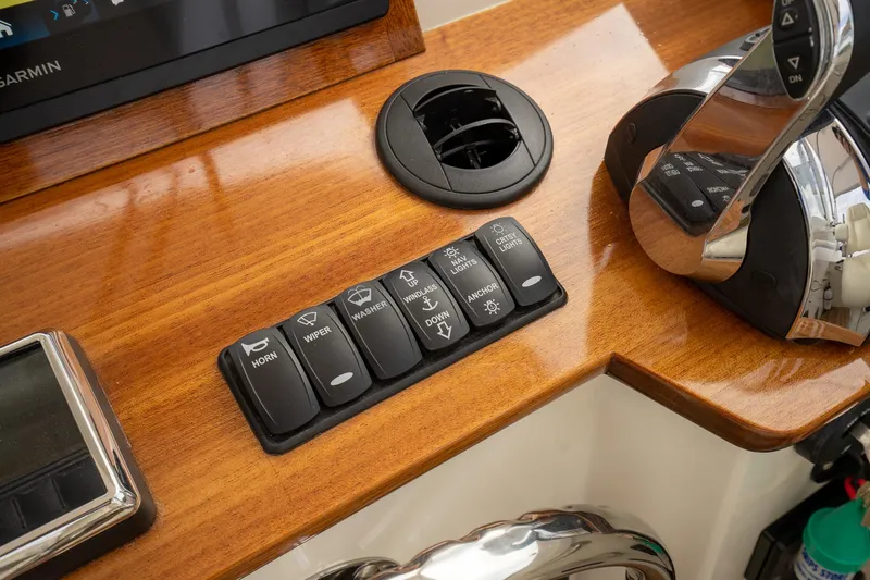Slide: The Image of Control panel of 2021 Brooklin Boat Yard 32 Express with switches and throttle lever. - 40