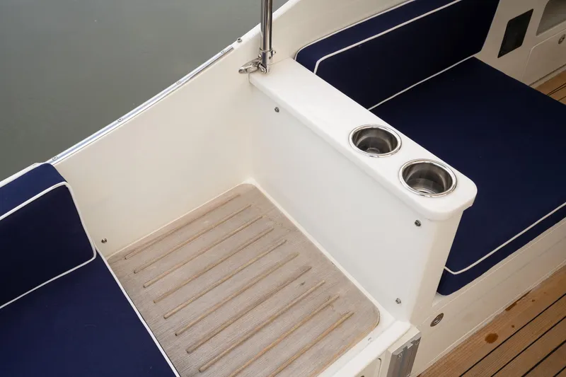 Slide: The Image of 2021 Brooklin Boat Yard 32 Express interior with blue seating and dual cup holders. - 43