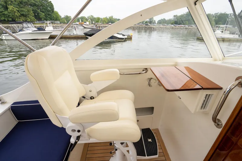 Slide: The Image of Luxurious interior of 2021 Brooklin Boat Yard 32 Express with cream seating and wooden accents. - 47