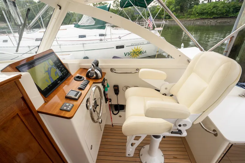 Slide: The Image of Helm of 2021 Brooklin Boat Yard 32 Express with navigation equipment and comfortable seating. - 48