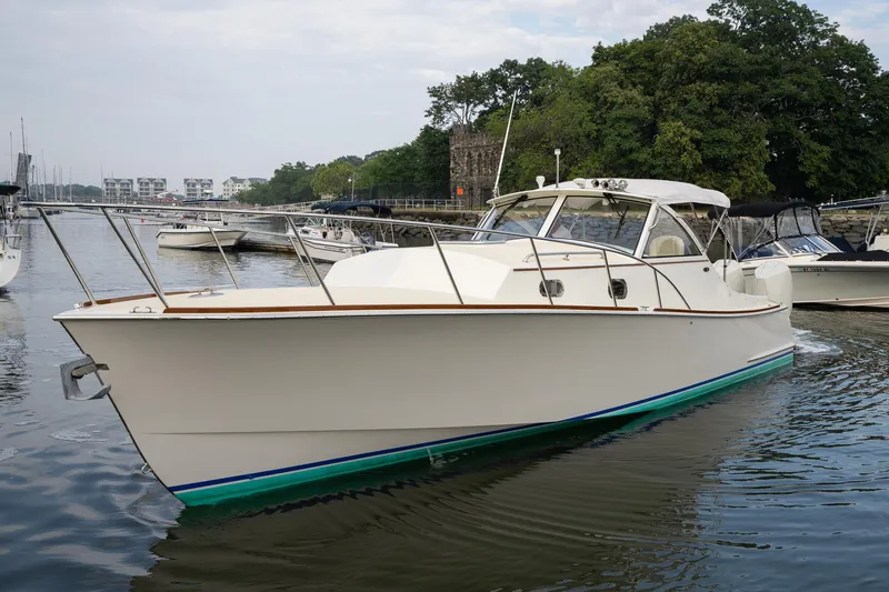 Slide: The Image of 2021 Brooklin Boat Yard 32 Express cruising in a marina, surrounded by other boats. - 6