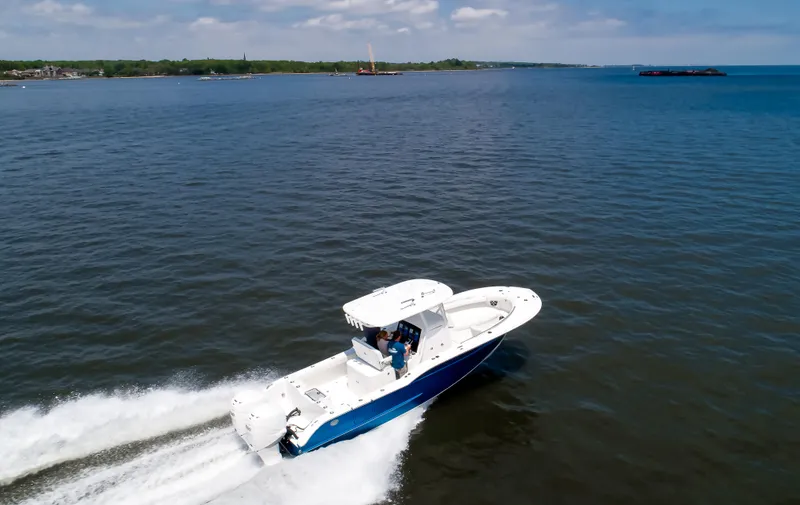 Slide: The Image of 2025 Buddy Davis 28 Center Console boat cruising on open water. - 19