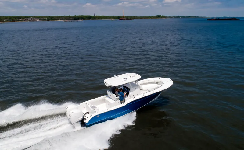 Slide: The Image of 2025 Buddy Davis 28 Center Console boat cruising on open water. - 21