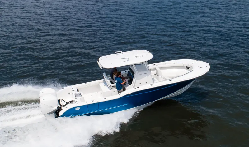 Slide: The Image of 2025 Buddy Davis 28 Center Console boat cruising on open water. - 24