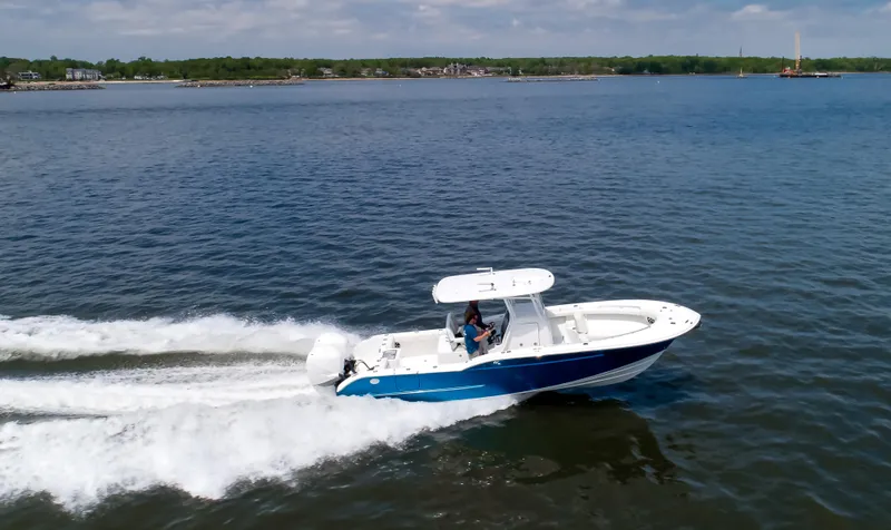Slide: The Image of 2025 Buddy Davis 28 Center Console boat cruising on open water. - 25