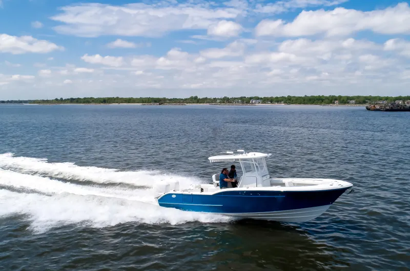 Slide: The Image of 2025 Buddy Davis 28 Center Console boat cruising on open water. - 31