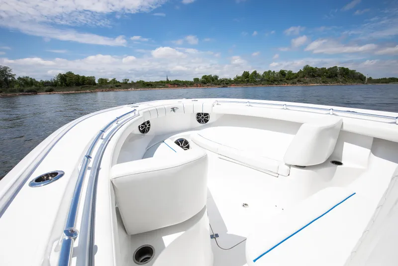 Slide: The Image of 2025 Buddy Davis 28 Center Console boat on calm water, featuring sleek white seating. - 39