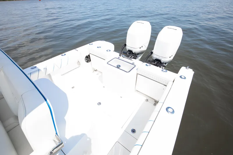Slide: The Image of 2025 Buddy Davis 28 Center Console boat with dual outboard engines on calm water. - 42