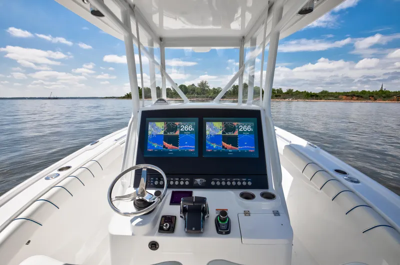 Slide: The Image of 2025 Buddy Davis 28 Center Console boat with advanced navigation system on calm water. - 44
