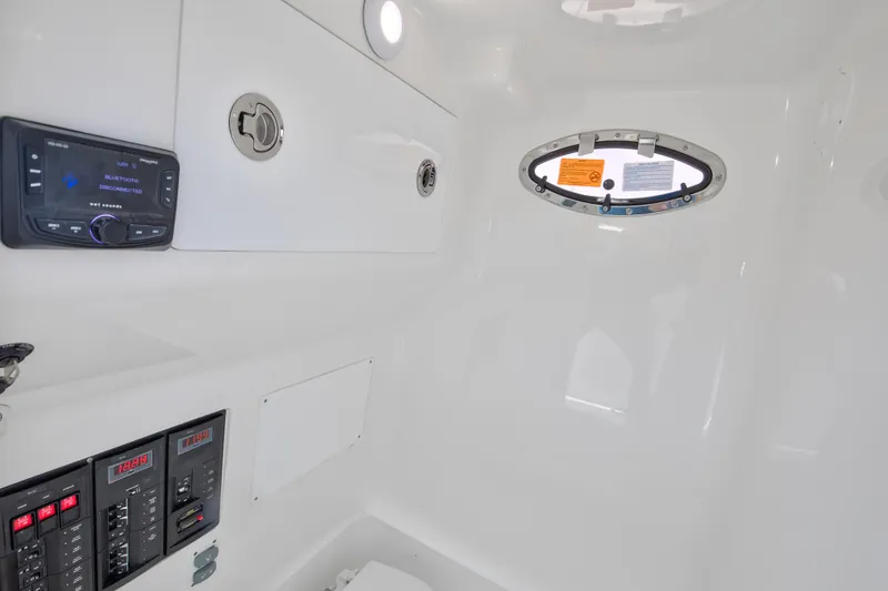 Slide: The Image of Interior of 2025 Buddy Davis 28 Center Console boat, featuring control panels and porthole. - 47