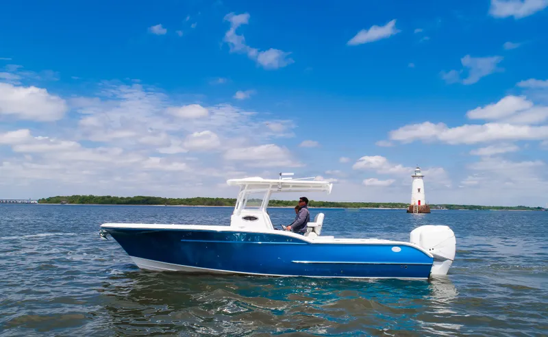 Slide: The Image of 2025 Buddy Davis 28 Center Console boat on open water, clear sky background. - 9