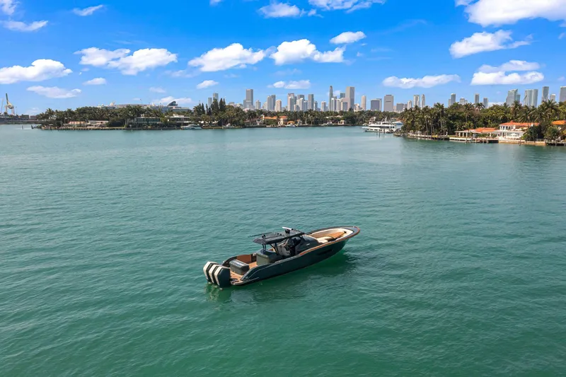 Slide: The Image of Buddy Davis PININFARINA 47 CC boat on water with city skyline in background, 2025 model. - 13