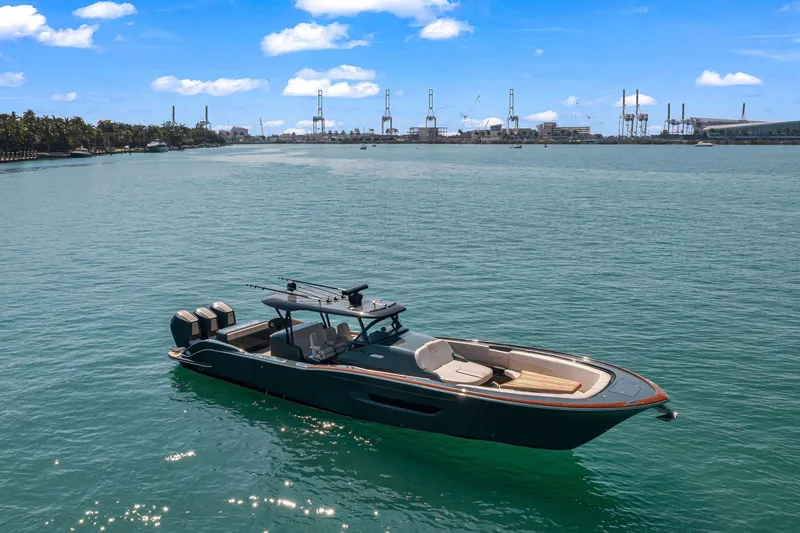 Slide: The Image of 2025 Buddy Davis PININFARINA 47 CC boat on calm water, industrial skyline in background. - 14