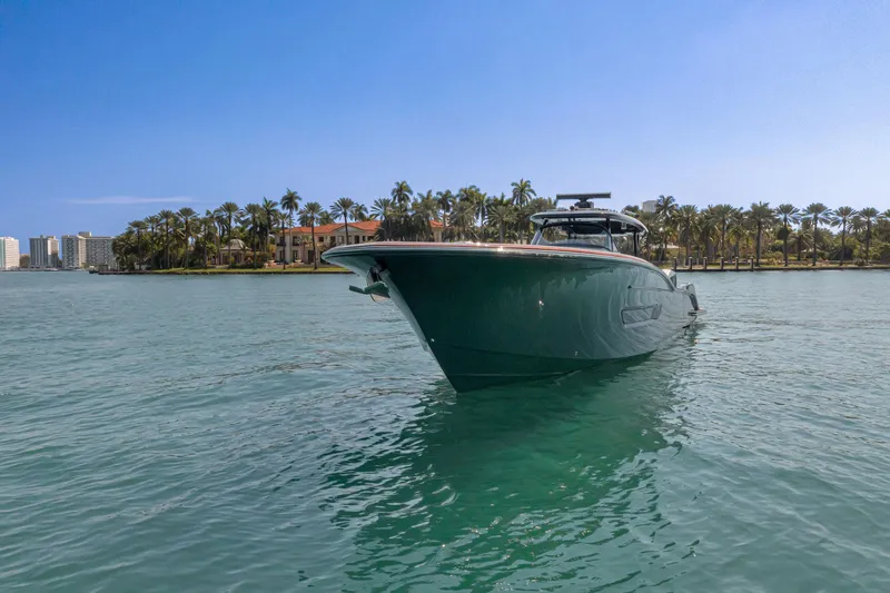 Slide: The Image of 2025 Buddy Davis PININFARINA 47 CC yacht on serene water with palm trees. - 19