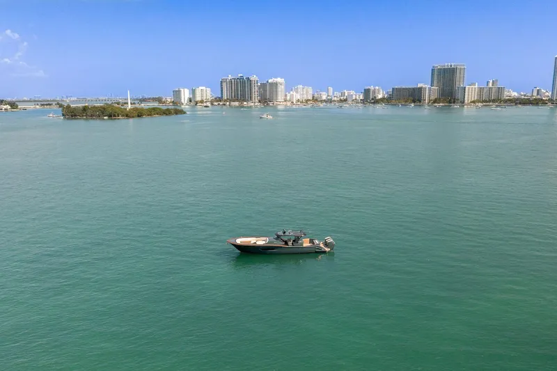 Slide: The Image of Boat on calm water with city skyline; 2025 Buddy Davis PININFARINA 47 CC. - 22