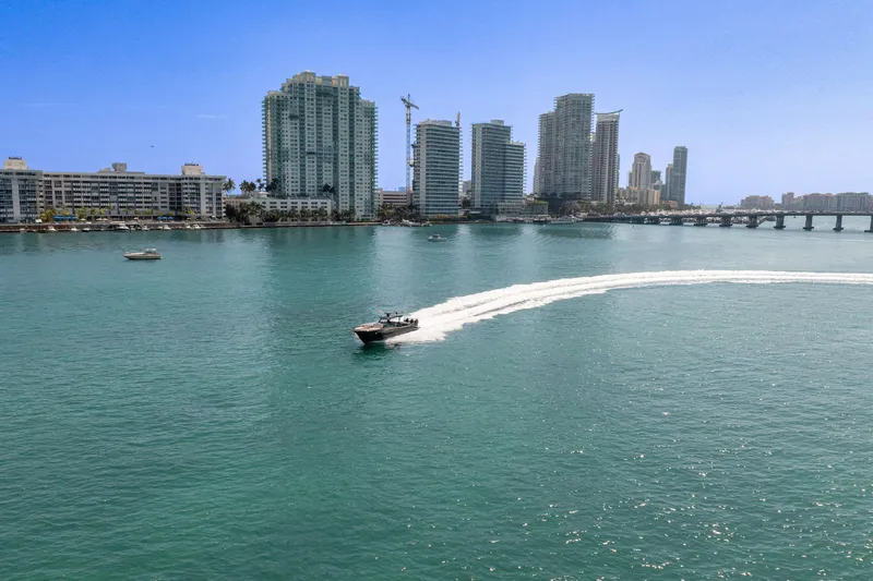 Slide: The Image of Boat cruising near city skyline, Buddy Davis PININFARINA 47 CC, 2025 model. - 26