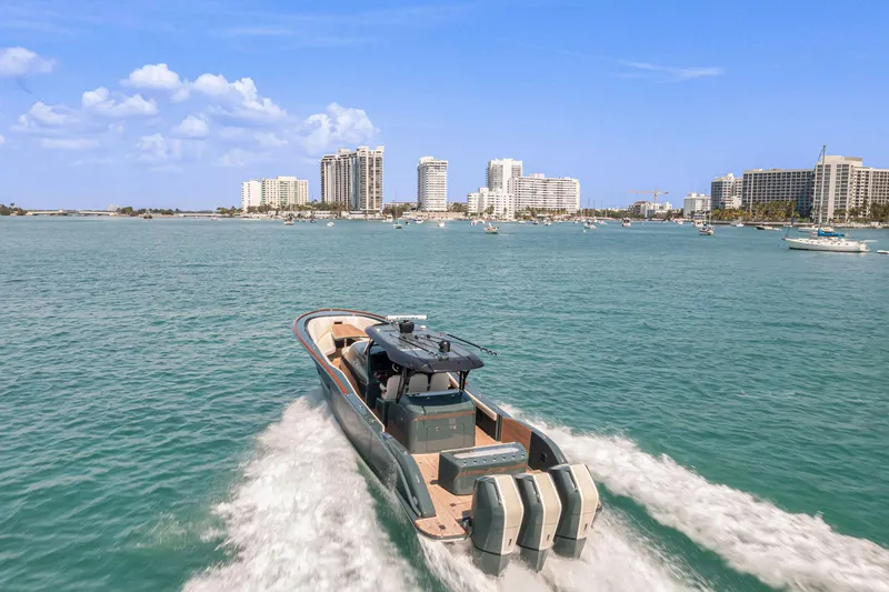 Slide: The Image of 2025 Buddy Davis PININFARINA 47 CC boat cruising in sunny coastal waters. - 32