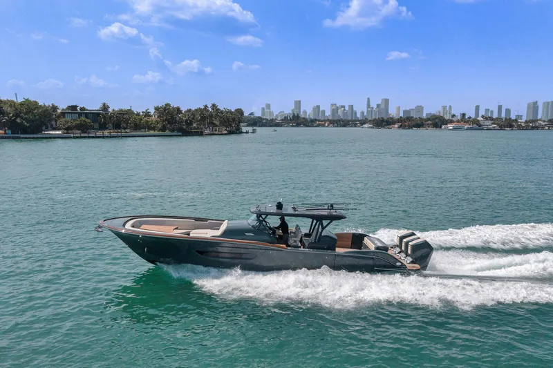 Slide: The Image of 2025 Buddy Davis PININFARINA 47 CC cruising on a sunny day with city skyline backdrop. - 34