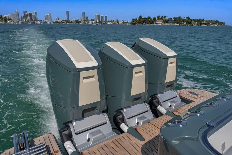 Slide: The Image of Triple outboard motors on 2025 Buddy Davis PININFARINA 47 CC, cruising near city skyline. - 40