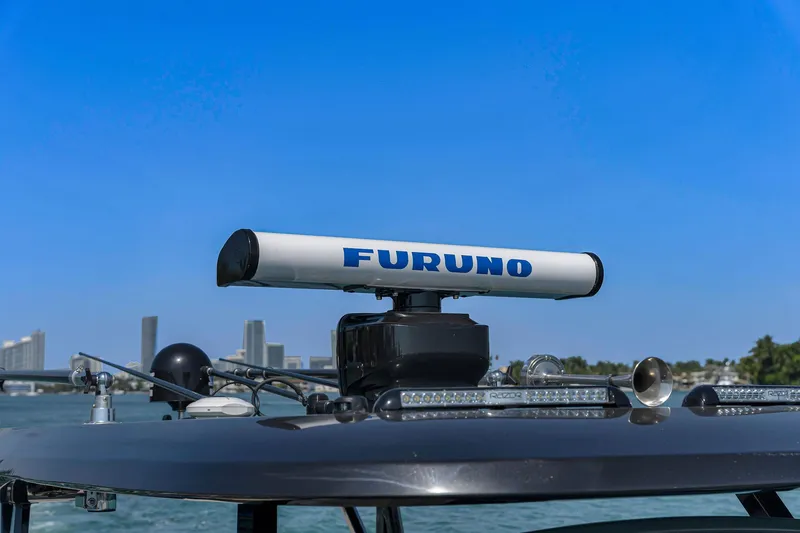Slide: The Image of Furuno radar on 2025 Buddy Davis PININFARINA 47 CC boat, city skyline in background. - 44