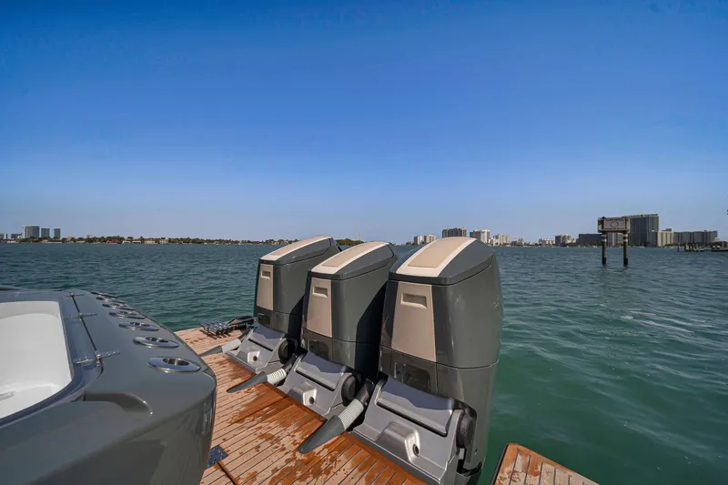 Slide: The Image of 2025 Buddy Davis PININFARINA 47 CC boat with triple outboard motors on a sunny day. - 46