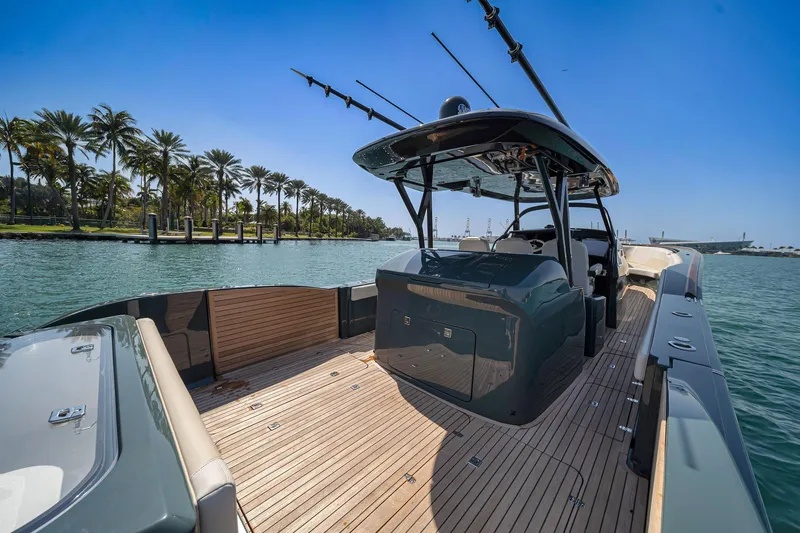 Slide: The Image of 2025 Buddy Davis PININFARINA 47 CC luxury boat on serene water with palm trees. - 49