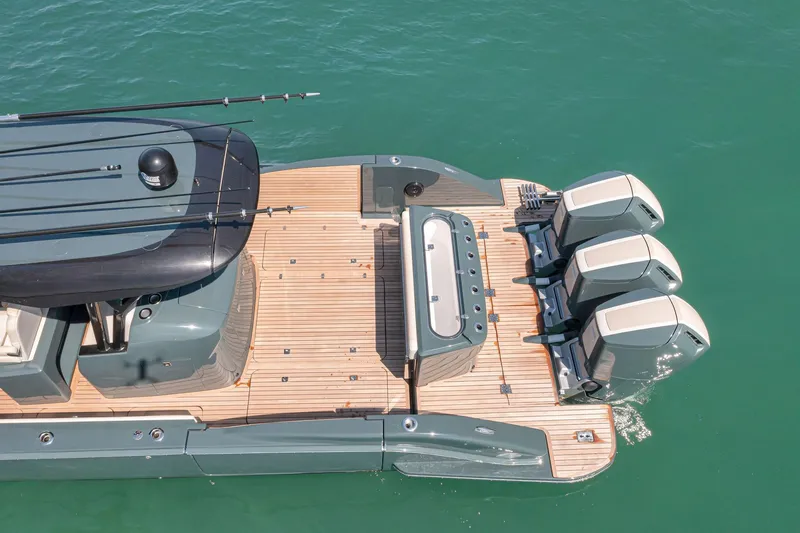 Slide: The Image of 2025 Buddy Davis PININFARINA 47 CC boat with triple outboard engines on turquoise water. - 5