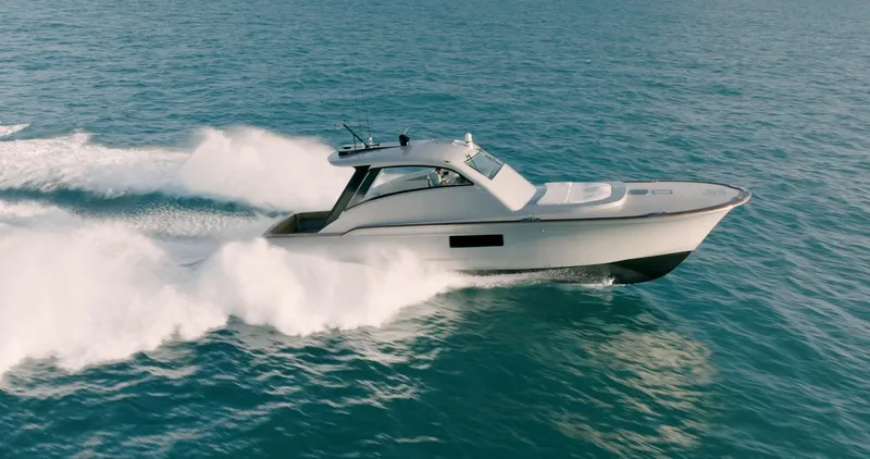Slide: The Image of 2025 Buddy Davis 52 Express yacht cruising on open water. - 11