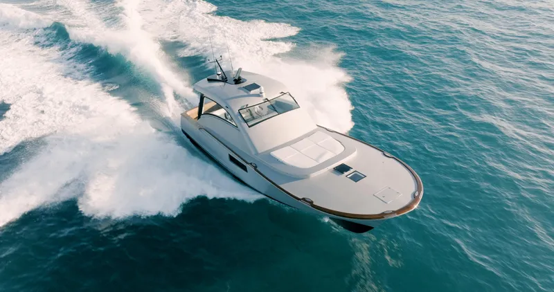 Slide: The Image of 2025 Buddy Davis 52 Express yacht cruising on open water. - 14