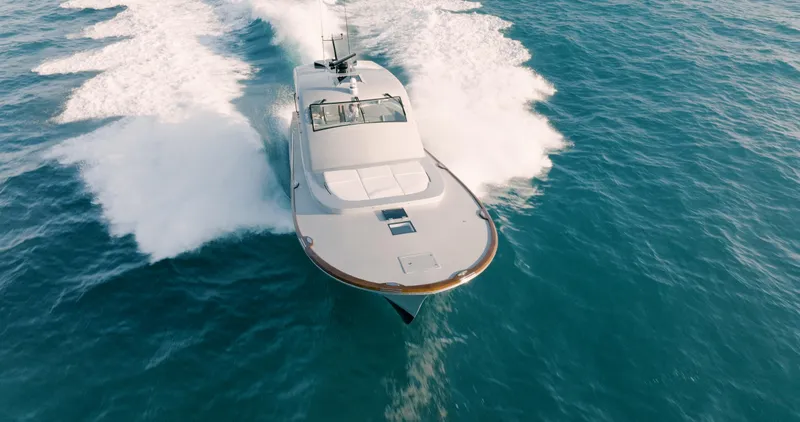 Slide: The Image of 2025 Buddy Davis 52 Express yacht cruising on open water. - 15