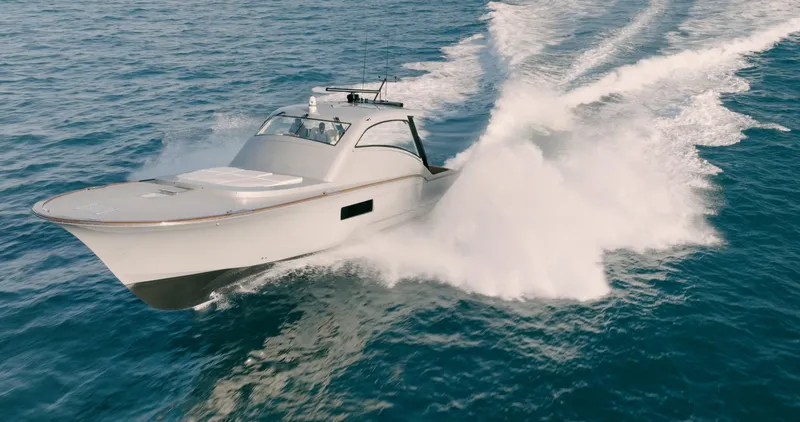 Slide: The Image of 2025 Buddy Davis 52 Express yacht cruising swiftly on open water. - 16