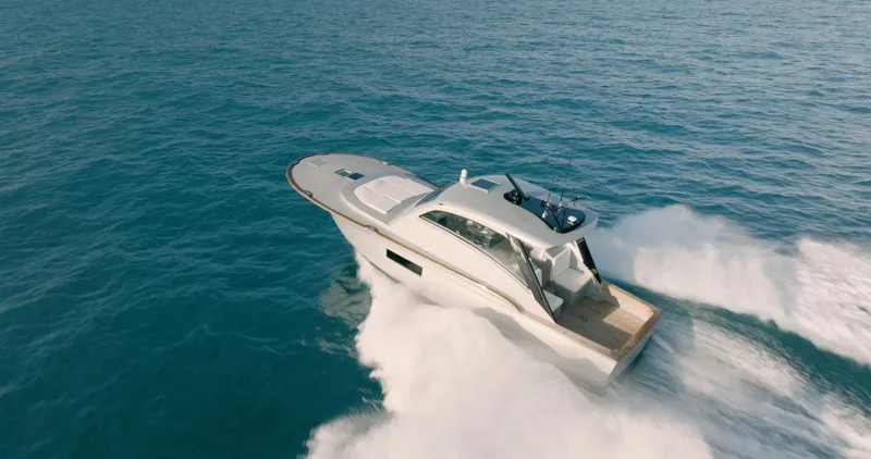 Slide: The Image of 2025 Buddy Davis 52 Express yacht cruising on open water. - 18