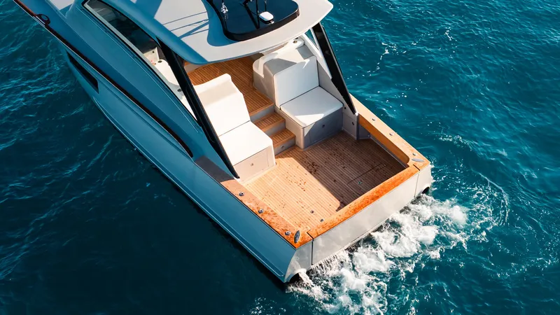 Slide: The Image of 2025 Buddy Davis 52 Express yacht cruising on blue ocean waters. - 21