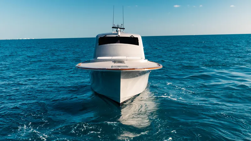 Slide: The Image of 2025 Buddy Davis 52 Express yacht cruising on open ocean waters. - 24