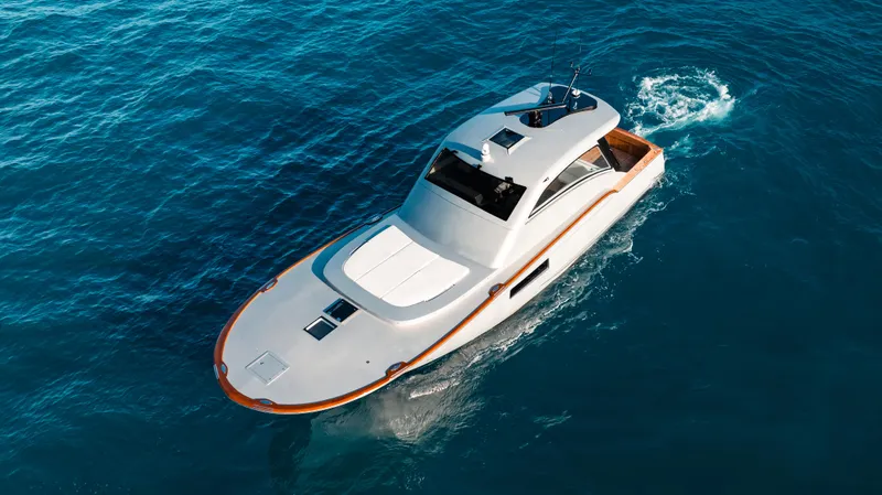 Slide: The Image of 2025 Buddy Davis 52 Express yacht cruising on clear blue water. - 25