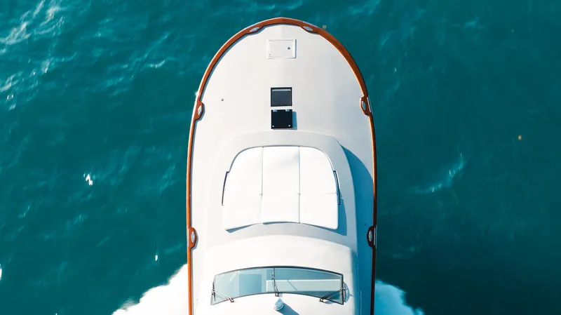 Slide: The Image of Aerial view of 2025 Buddy Davis 52 Express yacht cruising on blue ocean waters. - 28