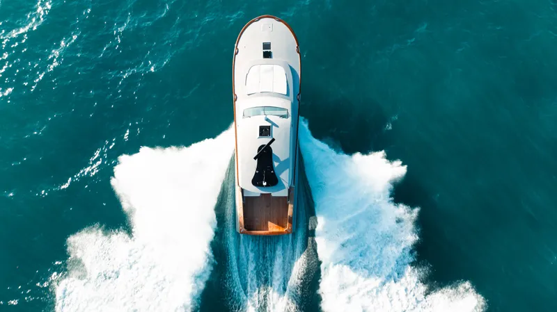 Slide: The Image of Aerial view of 2025 Buddy Davis 52 Express yacht cruising on blue ocean waters. - 29