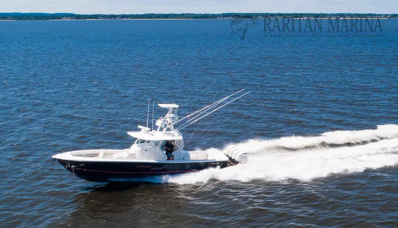 Slide: The Image of 2016 Regulator 41 boat cruising on open water, Raritan Marina in background. - 13